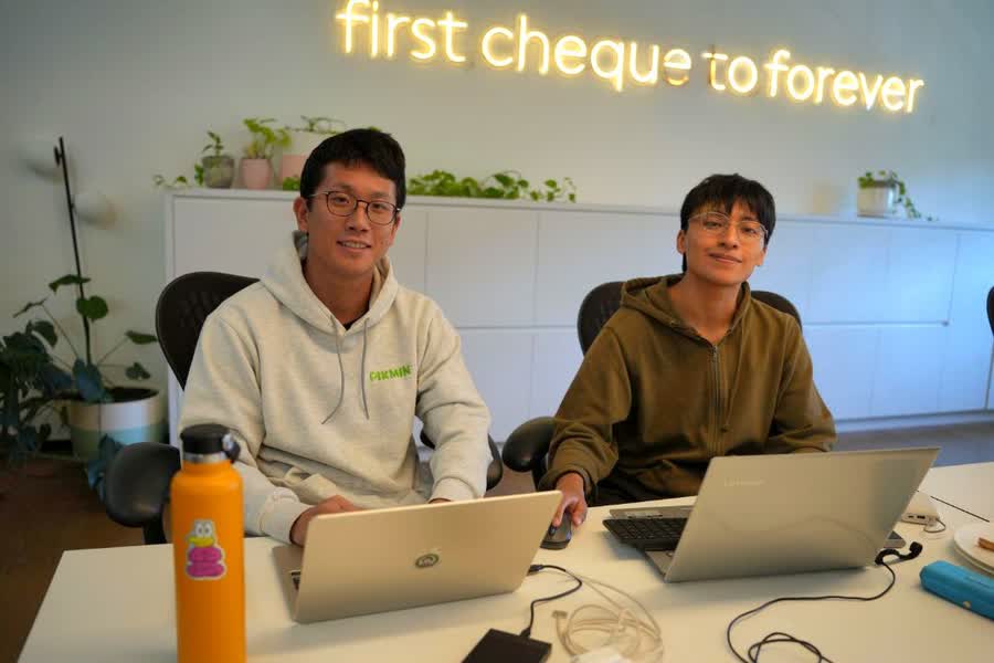 Ryan and Marlon working at their laptops.